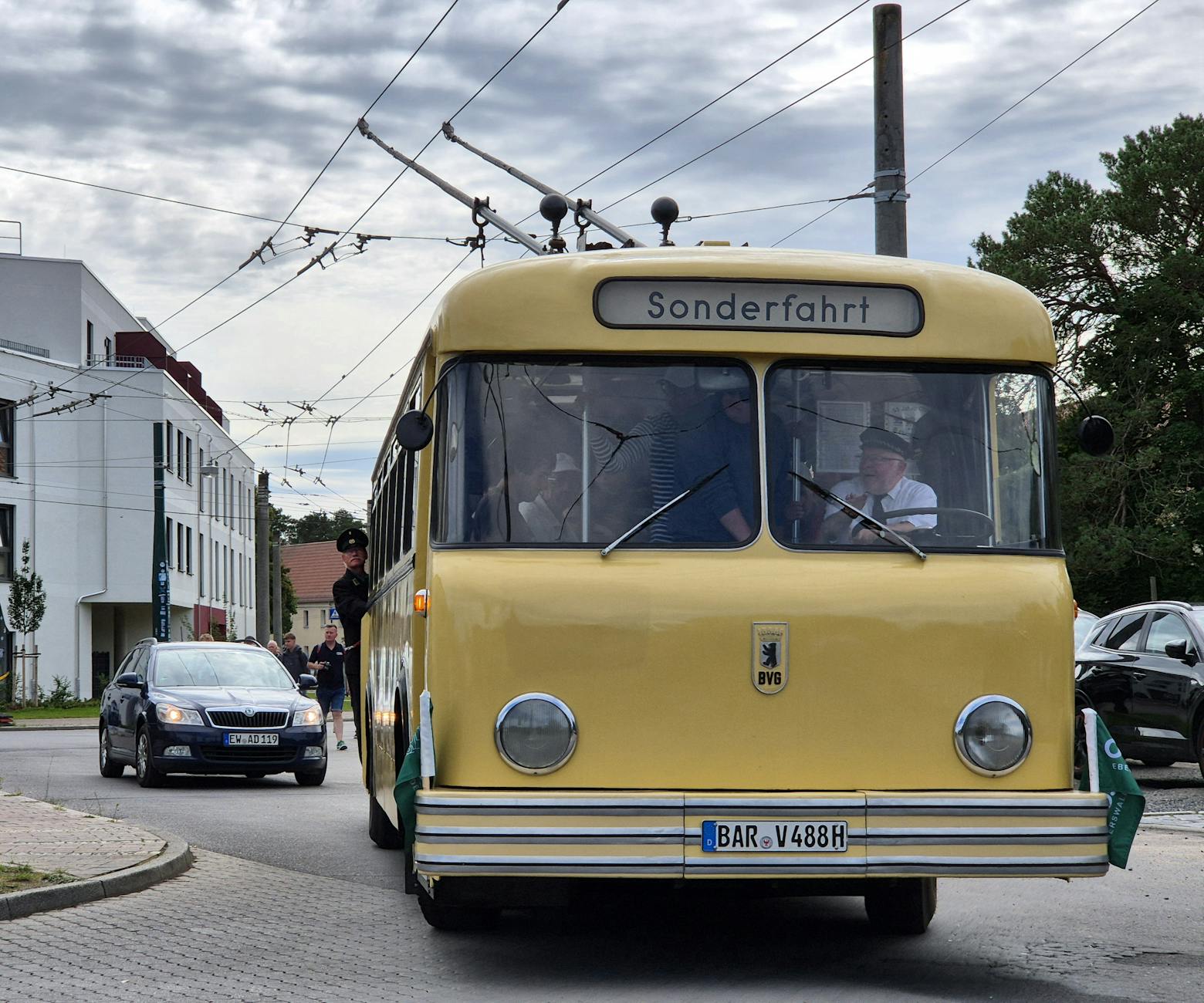 Vintage trolleybus captured during a special 'Sonderfahrt' tour in a scenic European town.